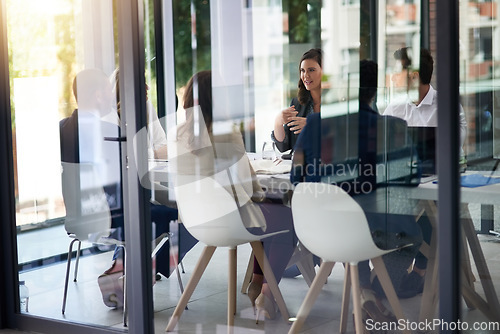 Image of Meeting, boardroom and collaboration with a business team in a glass office for planning or strategy. Corporate, management and training with an employee group in the workplace for a training seminar