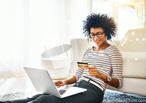 Image of Young woman, laptop and credit card with bokeh doing online shopping sitting on ground. Home, happiness and computer of happy African female person on a web ecommerce app reading an internet deal