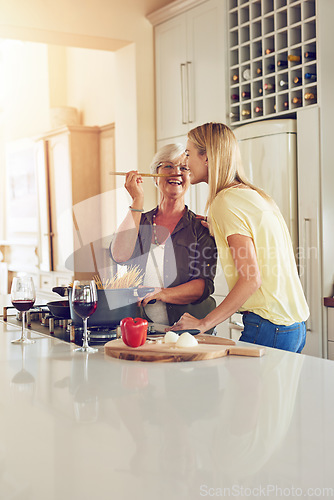 Image of Taste, woman or happy mother cooking food for a healthy vegan diet together with love in family home. Smile, tasting or adult daughter eating or helping senior mom in house kitchen at lunch or dinner