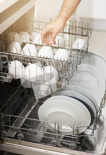 Image of Dishwasher machine, cleaning and hands of person washing dirty kitchenware for easy housekeeping, hygiene and housework. Closeup of electrical appliance for dishes, cups and plates in kitchen at home