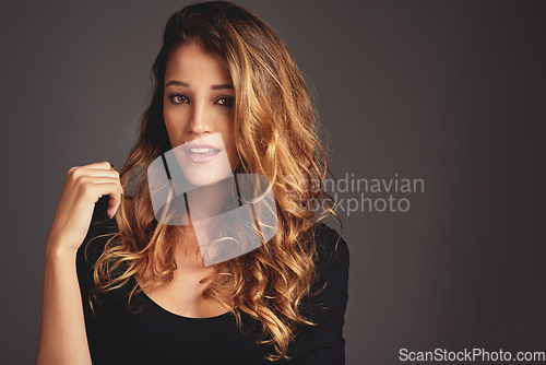 Image of Woman, beauty and hair care portrait in studio with makeup, cosmetics and skin glow on a grey background. Face of aesthetic female model person with salon results, shine and style with mockup space