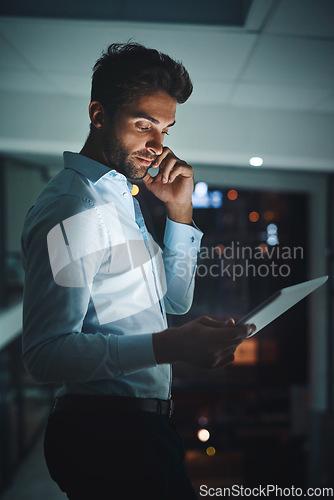 Image of Night, tablet and phone call with a business man in the office to research information for a project. Communication, networking and contact on a mobile with a male employee working in the evening
