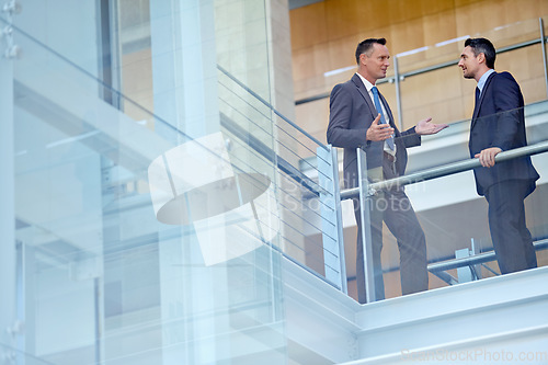 Image of Teamwork, collaboration or business people in office building lobby for communication, planning or speaking strategy. Corporate, manager or employees for meeting, idea discussion or talking together