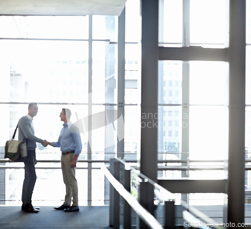 Image of Business people, handshake or greeting in hotel lobby, modern office or airport lounge in CRM team meeting. Corporate men, employees or shaking hands in partnership deal, collaboration or agreement