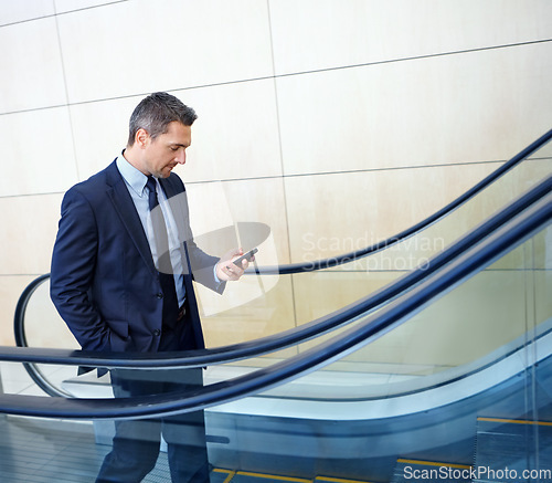 Image of Chat, email and businessman with a phone for contact, internet and app. Executive, communication and corporate employee typing on a mobile for social media, work and online trading on an elevator