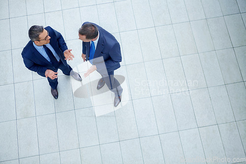 Image of Corporate, top view and business people talking for planning company strategy, finance growth and financial review. Teamwork, meeting or staff in lobby for collaboration, data analysis or idea search