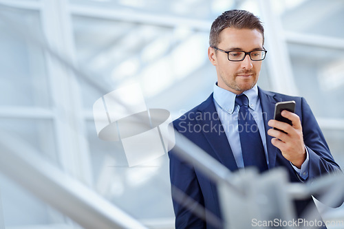 Image of Networking, corporate or business man with phone for internet research, social media at hotel lobby before trip to an airport. Tech, online or ceo in on smartphone for travel blog review or app