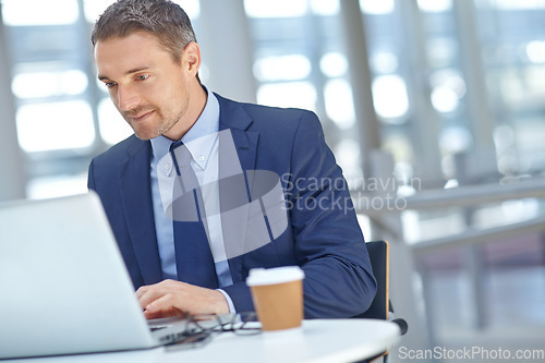 Image of Corporate, office and businessman working on a project or company report with a deadline on a laptop. Success, computer and professional male employee from Canada planning a proposal in the workplace