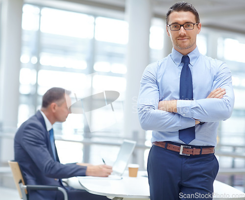 Image of Portrait, growth and mindset with a business man in his office standing arms crossed in a confident pose. Vision, mission and management with a male employee at work for future success in corporate