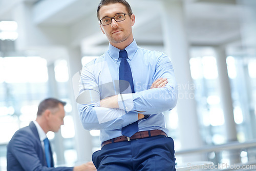 Image of Portrait, mission and mindset with a business man in his office standing arms crossed in a confident pose. Growth, vision and management with a male employee at work for future success in corporate