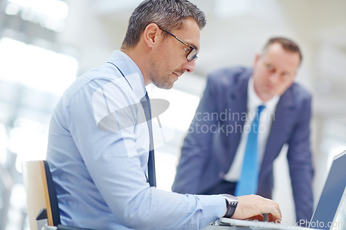 Image of Business man, laptop or research for talking colleague, question or review for job or work performance at desk. Corporate boss, employees or people in discussion on computer or information technology