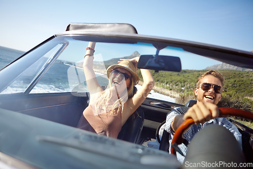Image of Car road trip, travel and happy couple on ocean holiday adventure, transportation journey or fun summer vacation. Love bond, convertible automobile and driver driving on Australia countryside tour