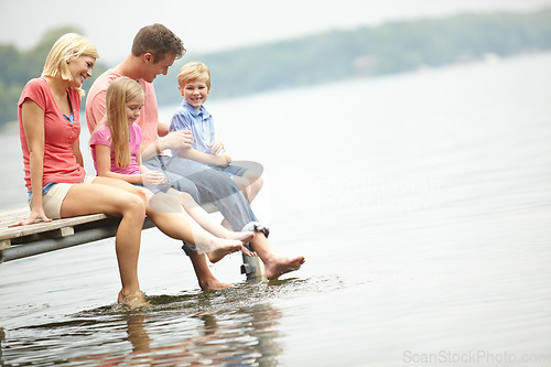 Image of Holiday, lake and family with kids with foot in water during summer vacation in the outdoor with space. Deck, parent and child at an adventure together with sunshine and freedom to travel in mock up.