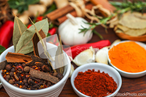 Image of Food, leaf and spices on table top for cooking meal, turmeric seasoning or paprika flavor. Vegetables, kitchen condiments and variety of plant herbs in bowls for brunch, healthy diet or vitamins.