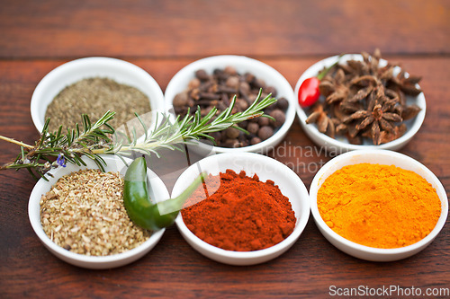 Image of Food, turmeric and spices on table top for cooking gourmet meal, pepper seasoning or paprika flavor. Vegetables leaf, kitchen condiments and variety of plant herbs in bowls for brunch or healthy diet