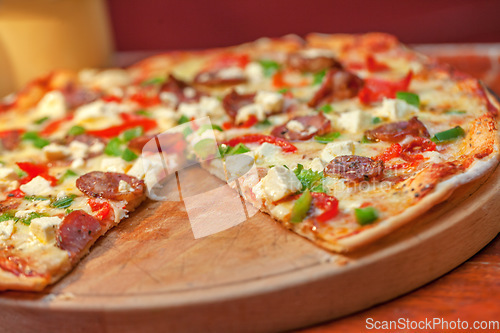 Image of Food, cheese and pizza on table in restaurant with mozzarella, salami and herbs. Cooking, kitchen and fresh margherita, bread and delicious gourmet pie, dish or fastfood meal from small business.