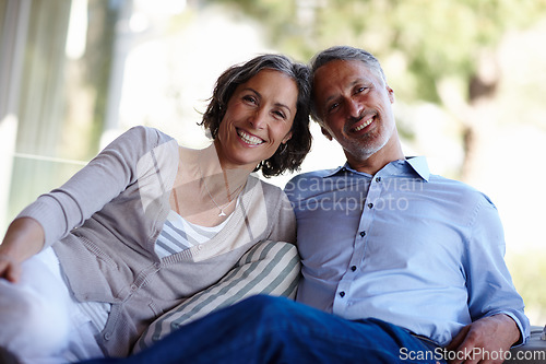 Image of Portrait, love and senior couple on a couch, romance and relationship with happiness, home and retirement. Face, mature man and old woman on a sofa, romantic and marriage with bonding and loving