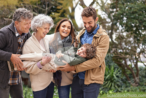 Image of Family, child and grandparents or parents playing with kid in a park on outdoor vacation, holiday and excited together. Backyard, happiness and people play as love, care and bonding in nature