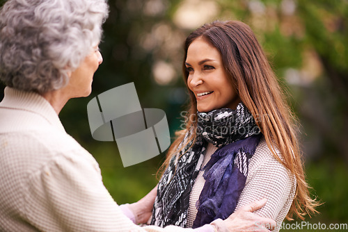 Image of Smile, care and woman with grandmother together on a outdoor vacation or holiday bonding in happiness. Retirement, women and young happy female person in conversation and laughing with mom