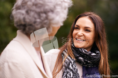 Image of Smile, grandmother and woman with elderly parent together on a outdoor vacation or holiday bonding in happiness. Retirement, women and young happy female person in conversation and laughing with mom