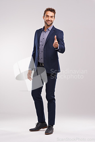 Image of Business man in portrait, smile and handshake for agreement and onboarding on studio background. Corporate deal, hiring with thank you or welcome, partnership and collaboration with professional male