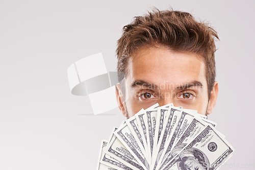 Image of Man, portrait and money fan in front of face with cash, dollars and financial success isolated on studio background. Economic stability, finance and bonus with reward, wealthy male and mockup space