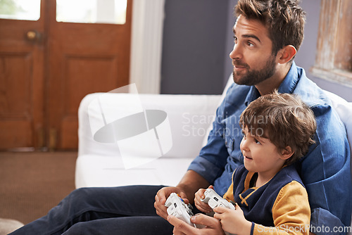 Image of Video games, father and son on a sofa, entertainment and relax at home, kid and fun in the lounge. Family, dad or boy with parent, male child and controller on a couch, happiness or multiplayer app