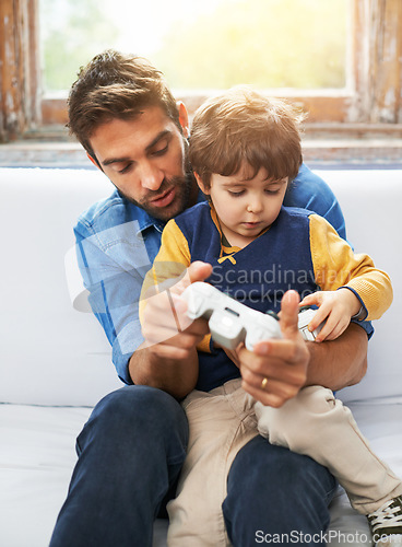 Image of Gaming, father and son on a sofa, video game and loving at home, quality time and relax in the lounge. Family, happy dad and boy with parent, male child and gamer playing online, cyber and carefree