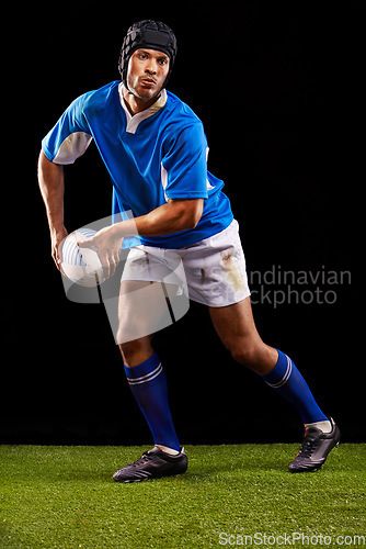 Image of Rugby, dark and man sports athlete pass a ball at night in black studio background training, wellness and fitness. Exercise, workout and professional career of sport male person or player on grass