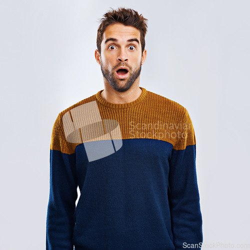 Image of Shock, portrait and male model in a studio with an amazed or surprise facial expression or attitude. Shocked, amazing news and man with a wtf, omg or wow face emoji isolated by a white background.