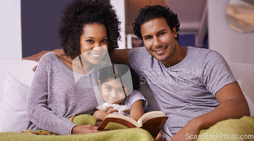 Image of Family, child and reading book portrait in a home for story time on a lounge sofa with a smile. A woman, man or parents and girl child together for development, learning and love with a fantasy