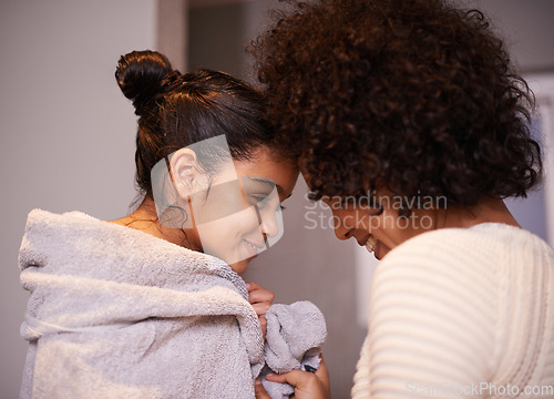 Image of Mother, child in bath towel and close for love, bonding and hugging after cleaning, shower and routine in a bathroom. Washing, embrace and mom with girl, loving and care after a bath in their home