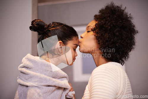 Image of Love, kiss and mother with girl in a bathroom for cleaning, bonding and bonding after shower routine. Washing, towel and mom kissing forehead of child after bath, sweet and caring in their home
