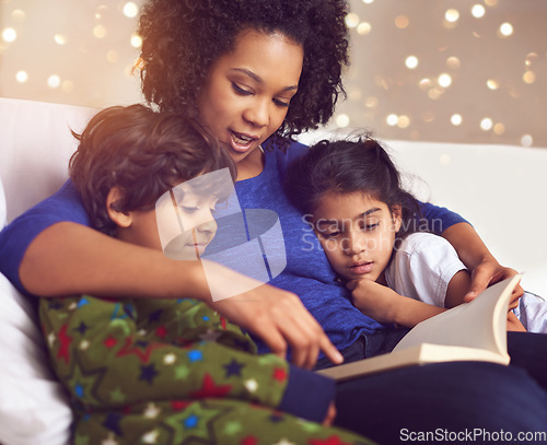 Image of Children, mother and reading a book in a family home for story time on lounge sofa with bokeh. A woman or mom with kids together for development, learning and love with a fantasy, magic or fairytale