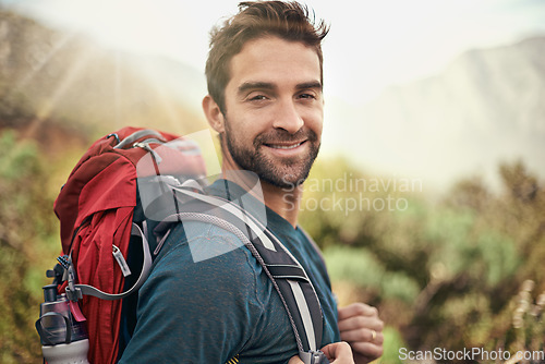 Image of Hiking, adventure and portrait of man on mountain for fitness, relax and travel journey. Backpack, summer and workout with male hiker trekking in nature path for training, freedom and explore