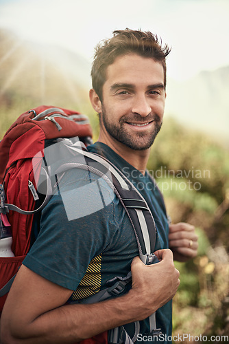 Image of Hiking, fitness and portrait of man on mountain for peace, adventure and travel journey. Backpacking, summer and workout with male hiker trekking in nature path for training, freedom and explore