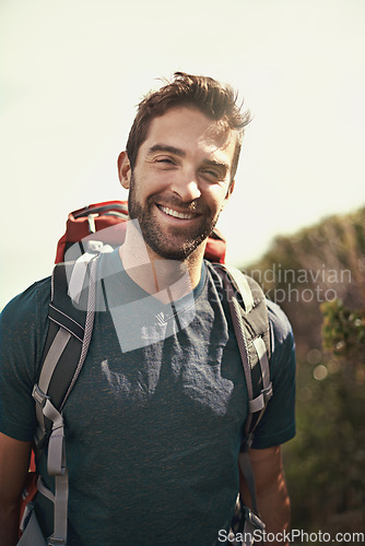 Image of Hiking, smile and portrait of man on mountain for fitness, adventure and travel journey. Backpack, summer and workout with face of male hiker trekking in nature path for training, freedom and explore