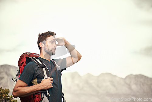 Image of Trekking, mountain and man on an adventure thinking after exercise, workout and fitness in nature for wellness. Travel, vacation and young male person on a break in mockup space, training and hiking