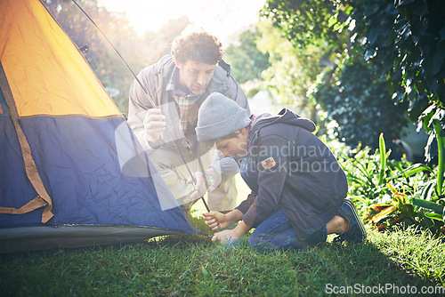 Image of Father, kid and preparing tent for camping outdoor in nature on vacation while bonding in summer sunset. Dad, boy and setting up camp, learning and getting campsite ready in forest for holiday travel