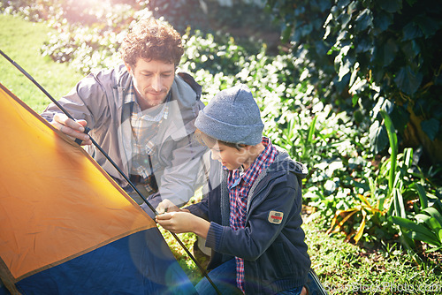 Image of Father, kid and set up tent for camping outdoor in nature on vacation while bonding in summer. Dad, boy and preparing campsite, learning and getting ready in forest for travel, education and holiday.