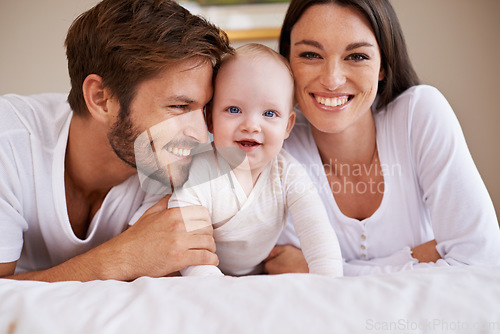 Image of Portrait, happy family and parents with baby on bed for love, care and quality time together at home. Mother, father and newborn child relaxing in bedroom for development, caring support or happiness