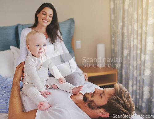 Image of Happy mother, father and fun with baby in bedroom for love, care and quality time to relax together at home. Mom, dad and parents playing with infant kid for happiness, support or newborn development
