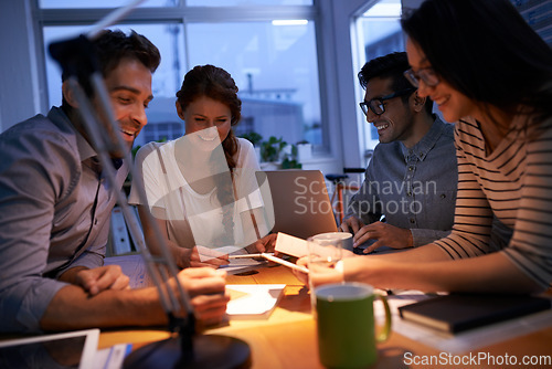 Image of Teamwork, night and business colleagues working in the boardroom for planning, strategy or innovation. Meeting, collaboration and overtime with a team or group of employees at work in the evening