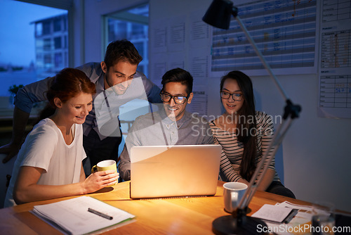 Image of Collaboration, night and an employee team on a laptop, working in the boardroom for planning, strategy or innovation. Meeting, teamwork and overtime with a business group at work in the evening