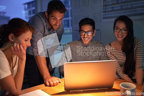 Image of Teamwork, night and a business group on a laptop, working in the boardroom for planning, strategy or innovation. Meeting, collaboration and overtime with a team of employees at work in the evening