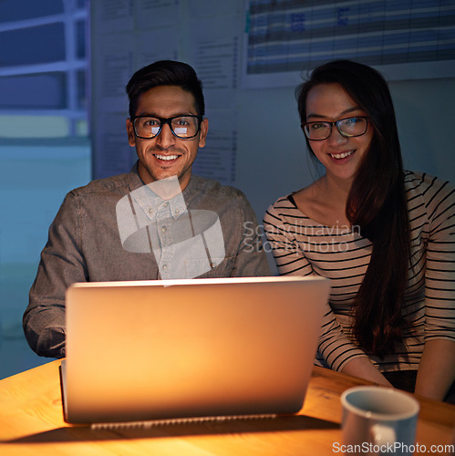 Image of Portrait, collaboration and night with businesspeople on a laptop, working in the boardroom for planning, strategy or innovation. Meeting, team or overtime with happy employees at work in the evening