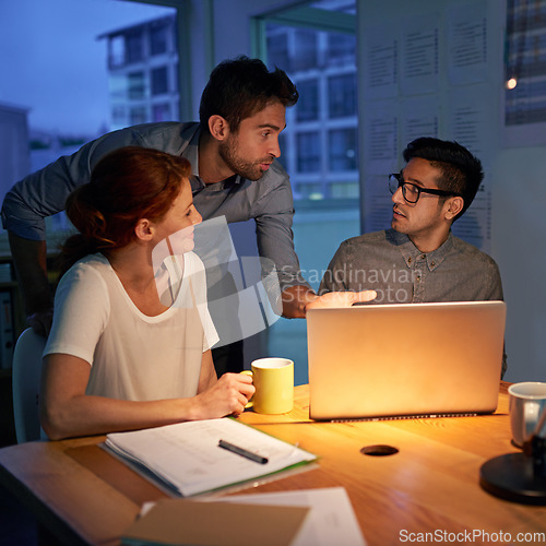 Image of Planning, night and a business team on a laptop, working in the boardroom for teamwork, strategy or innovation. Meeting, strategy or overtime with a group of employees at work together in the evening