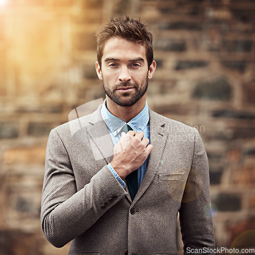 Image of Business man, portrait and urban wall with fashion, confidence and success in entrepreneurship. Young businessman, entrepreneur and suit in street, city or sidewalk with focus, style and motivation