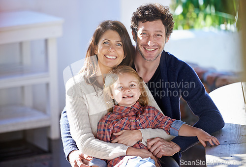 Image of Family in portrait, mother and father with child in backyard, relax together with love and care outdoor. Happy faces of people outside home, hugging with smile and woman, man with girl in a garden