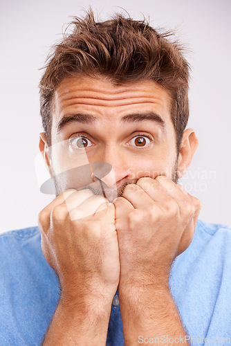 Image of Bite nails, portait and man with stress, anxiety and worried person isolated on a white studio background. Face, male model or guy with mental health issue, problem and doubt with bad habit